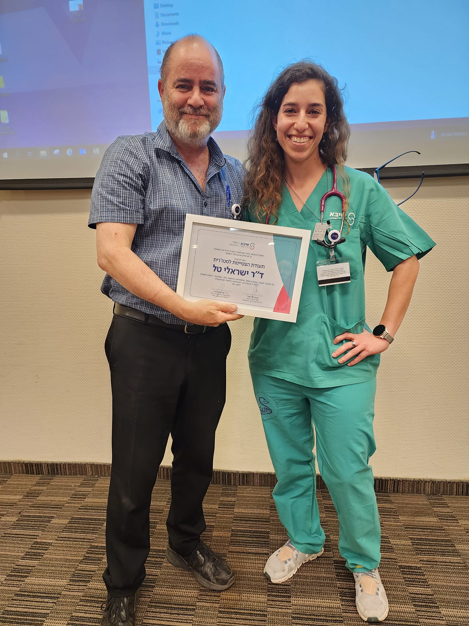 Accepting the Outstanding Intern Award at Sheba Medical Center